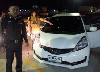 Dusit Thunprasert points to where a bullet entered his car through the windshield.