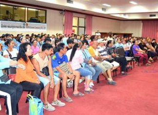 Theerasak Jatupong (right, with mic), head of the city’s Peace and Stability Maintenance Department, addresses about 200 Dongtan Beach masseuses.
