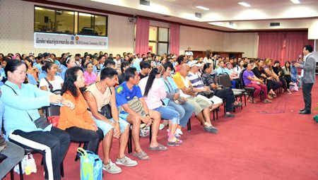 Theerasak Jatupong (right, with mic), head of the city’s Peace and Stability Maintenance Department, addresses about 200 Dongtan Beach masseuses.