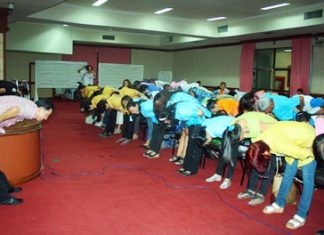 Pattaya meets with community leaders to develop health-spending priorities Mayor Itthiphol Kunplome (left) leads guests in some pre-meeting exercises.