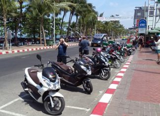 The city painted red & white no parking areas, but left some of the old white, angled motorcycle parking lines which now tend to confuse drivers.