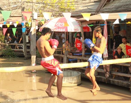 Pugilists get set to begin a “Muay Talay” (sea boxing) match at Pattaya Floating Market.