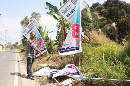 Rattanahcai Saengsri points out that that posters for three of six candidates in the Feb. 16 poll were shredded on Soi Wat Khaokhanman at the Yuttasart intersection.