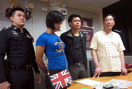 Transvestite prostitute Anusorn Chaiyong (2nd left) was caughtafter pick-pocketing a Chinese tourist.