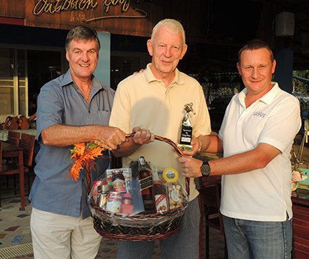 John Stafford (centre) collects the DeVere trophy from Greg Hirst (right) and his Black Label hamper from Pete Stonebridge (left).