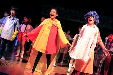 Students flood the stage for a full production song.