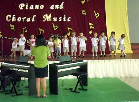 A group of young students dance and sing ‘Music is fun’.