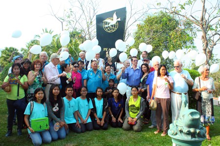 Rotarians and their families and friends gather around the Peace monument in celebration of peace towards all humanity.