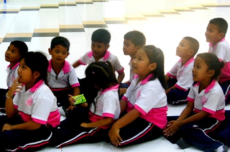 A group of children wait patiently.