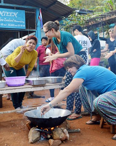 Head of Psychology Sara Calverley and PE Teacher Meena Charoensa-Nga prepare dinner.