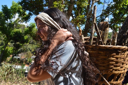 Daisy rolls up her sleeves and helps the hill tribe gather wood.
