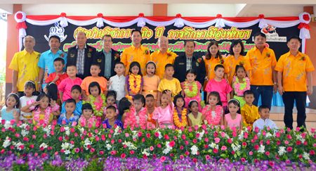 Young stage performers take to the stage with city officials.