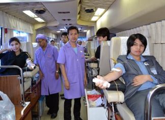 Employees at Pattaya’s King Power duty-free mall donate blood inside Queen Savang Vadhana Memorial Hospital’s 10-bed medically equipped bus.