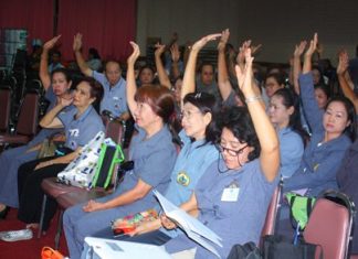 Pattaya Public health volunteers members raise their hands to approve Suphin Ruangrung as the next president of Pattaya Public Health Volunteers.