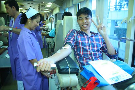 It only hurts for a minute, this smiling teenager says whilst donating blood.