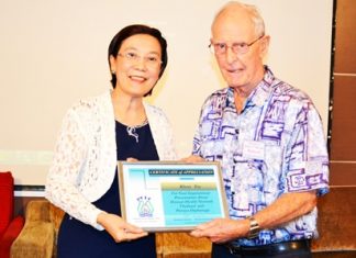 Toy from Pattaya Orphanage is presented a Certificate of Appreciation on behalf of the Pattaya City Expats Club by Board Member and former Chairman Richard Smith for her excellent presentation on the Pattaya Orphanage and the Human Help Network Foundation.
