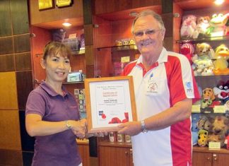 Wangjuntr Highlands – still polarizing opinions Derek Brook (right), on behalf of the Royal British Legion Thailand, presents a certificate of appreciation to the staff at Khao Kheow Country Club.