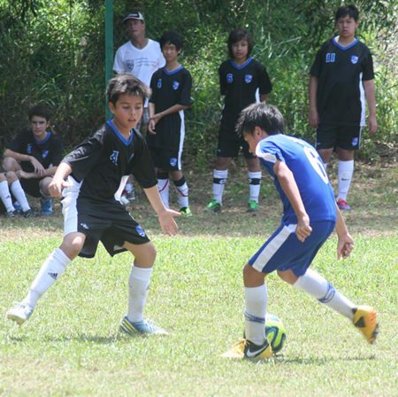 David from St. Andrews (left) challenges for the ball with an opposing team member from St. Stephens. 