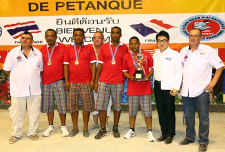 Victorious Madagascar team members hold the winner’s trophy as they pose for a photo with tournament officials at the conclusion of the event.