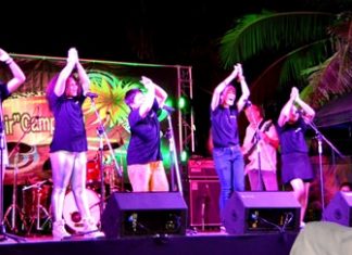 Students perform international choral music on stage.