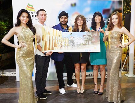 Apichart Gulati, Project Manager, Blue Sky Group Co., Ltd. (3rd left) presents gold prizes to lucky winners at the Sea of Prosperity party held at the Grande Caribbean Condo Resort Pattaya sales gallery on March 8.