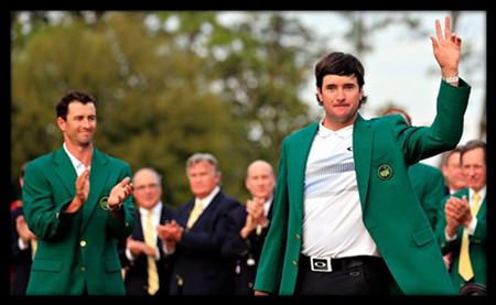 Bubba Watson waves after receiving the jacket from last year’s winner, Adam Scott.