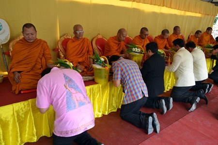 Government officials receive blessings from the Buddhist monks.