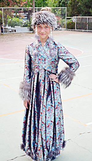 Young Siberian dancer in traditional costume.