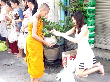 Novice Art receives alms from his sister.