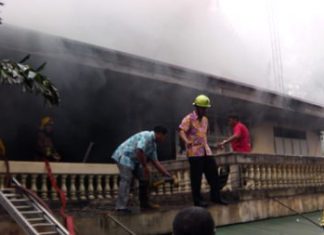 Firefighters work to extinguish a blaze in the abbot’s residence at Nongprue Temple.