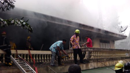 Firefighters work to extinguish a blaze in the abbot’s residence at Nongprue Temple.