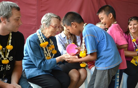 Children from Fountain of Life gently pour water on Sister Joan Gormley’s hands, asking for blessing and expressing their gratitude.