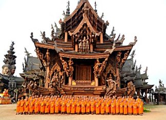 Over a hundred monks prepare to lead a parade throughout the greater Naklua, Pattaya and Jomtien areas so that people could sprinkle holy water on Buddhist relics from the Sanctuary of Truth. The relics were put on a special float (back, left) to give residents and tourists an opportunity to pour holy water on the relics on Songkran Day.