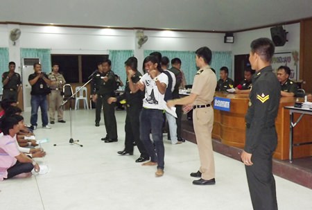 One of the males at the military conscription is ecstatic when picking the black card.