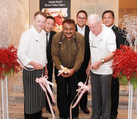 Pattaya Mail Media Group Managing Director Peter Malhotra (center) cuts the ribbon to officially launch the new Crab Feast Fridays, watched by Executive Chef Alistair Carter (front left), Dr Iain Corness (front right), and (back row, left to right) F& B Manager Pansak Pornwisawaraksakul, Tanaphol Rodpinyo, associate director of sales, and Pin Krasang, director of catering.