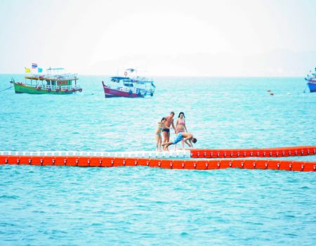 Currently, tourists are having fun walking on the buoys, but the city is putting larger gaps between the buoys to discourage their use as anything but a barrier to separate swimmers from boats and jet skis.