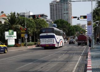 This tourist bus just drives straight through the red light without stopping as tourists wait to cross the road.
