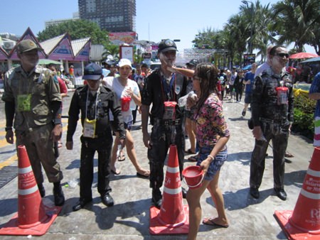 About 1,000 police officers and volunteers will slog through Pattaya April 19, just like these men, to provide security for the city’s Songkran finale.