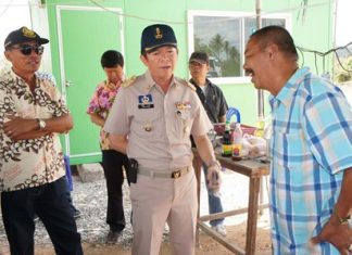 Banglamung District Chief Sakchai Taengho (center) questions Nong Plalai Sub-district Council President Banjet Thimthong (right) about what is thought to be illegal excavation of public land.