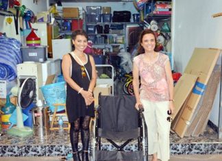 Margaret Grainger from the Hand to Hand Foundation (right) donates a surplus wheelchair to Saisamorn “Yui” Pithak (left) for her 94-year-old grandmother in Khon Kaen.