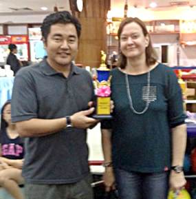 Edson Uehara (left) is presented with the top scoring adult prize by PILC President Helle Rantsen.