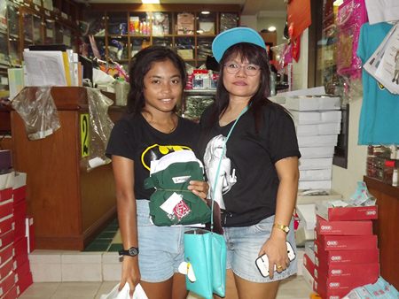 Mae takes daughter Pui to buy her school and Girl Scout uniforms.