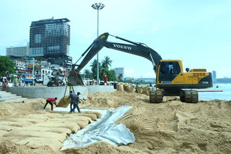 City-owned backhoes install large sandbags - each one 15 meters long, 4 meters wide and a meter thick - at the entrance to Pattaya Beach at the intersection of Beach and Central Roads. The 3.1 million baht project is another attempt by city officials to prevent beach erosion during the rainy season. 