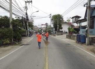 Workers prepare the road to have its dividing lines repainted.