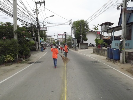 Workers prepare the road to have its dividing lines repainted.