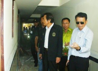 (L to R) Deputy Mayor Ronakit Ekasingh, PBTA President Sinchai Wattanasartsathorn, and Banglamung District Chief Sakchai Taengho inspect the illegal top floors at the Boutique Hotel on Soi VC.