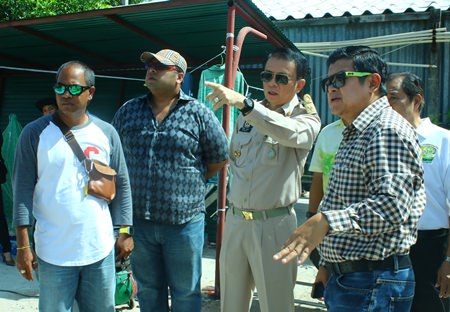 Banglamung District Chief Sakchai Taengho (2nd right) and Deputy Mayor Verawat Khakhay (right) inspect the progress of recovering the South Pattaya canal.