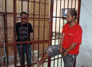 Sattahip jailers leave inmate alone, nearly lose him Somyos Anumat (right) shows police how he kicked open the cell door and nearly escaped.