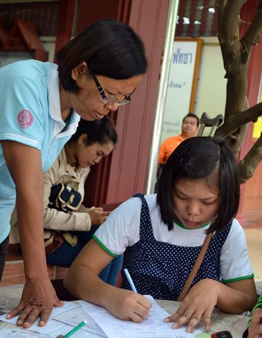 A parental guiding hand to make sure the forms are correct.
