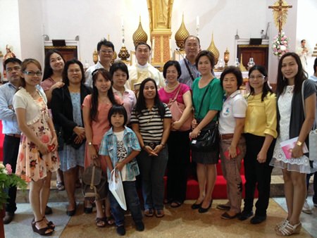 Rev. Peter Pattarapong Srivorakul poses with cousins during the celebration.